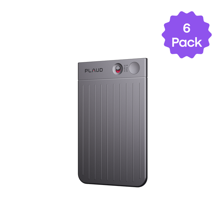 Dark gray Plaud AI voice recorder with ribbed texture, red button, and 'PLAUD' logo. A purple '6 Pack' sticker is in the corn
