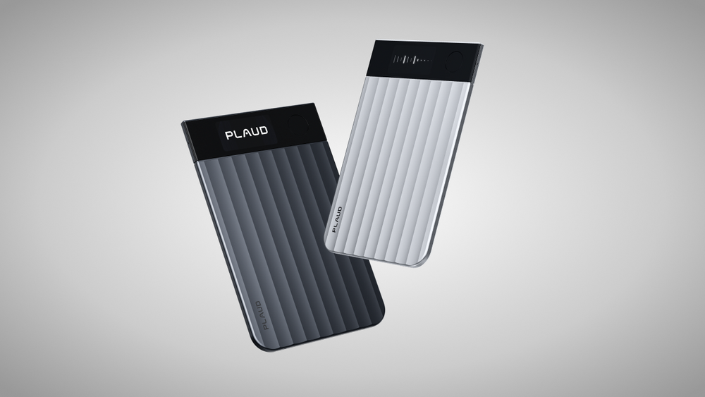 Two Plaud Note Pro devices, one dark gray and one white, showing their ribbed texture and display screens.