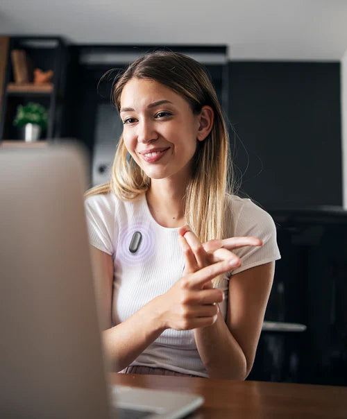 Smiling woman on a video call, wearing a black Plaud NotePin S on her white shirt, actively recording.